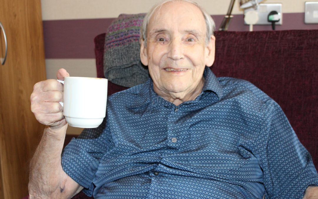 Older man holding cup